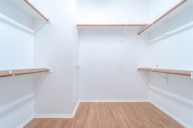 Walk in closet featuring wood finished floors | Image 30