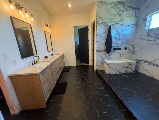 Bathroom with double vanity and a tub with marble appearance | Image 15