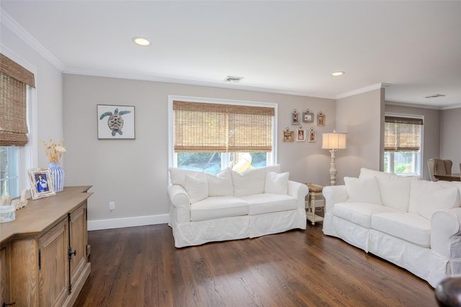 Living area with crown molding, dark wood-type flooring, and recessed lighting | Image 17