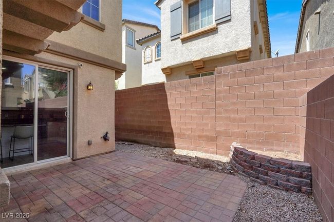 Fenced backyard with a patio area | Image 26
