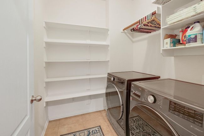 Large laundry room with built-in shelving and hanging space | Image 34