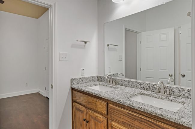 Bathroom featuring double vanity and wood finished floors | Image 20