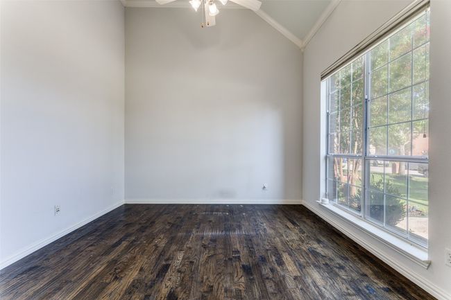 Unfurnished room featuring vaulted ceiling, ornamental molding, dark wood-type flooring, and a ceiling fan | Image 15