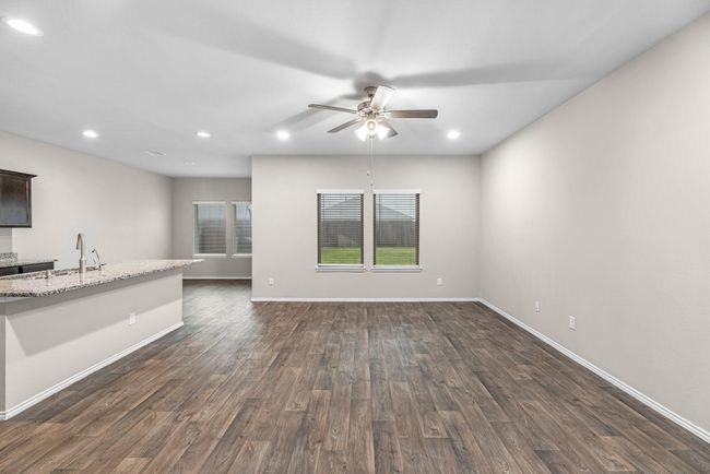 View of living/family room with views of the covered patio. | Image 19