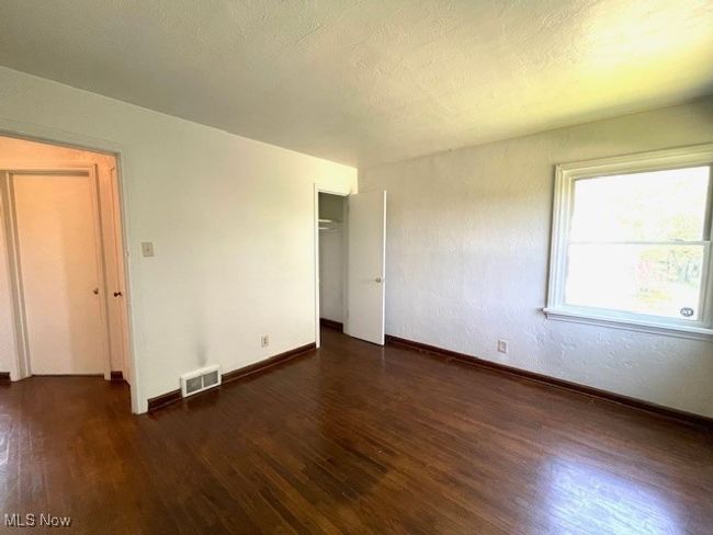 Second Bedroom with wood finished floors, baseboards, and a closet | Image 18