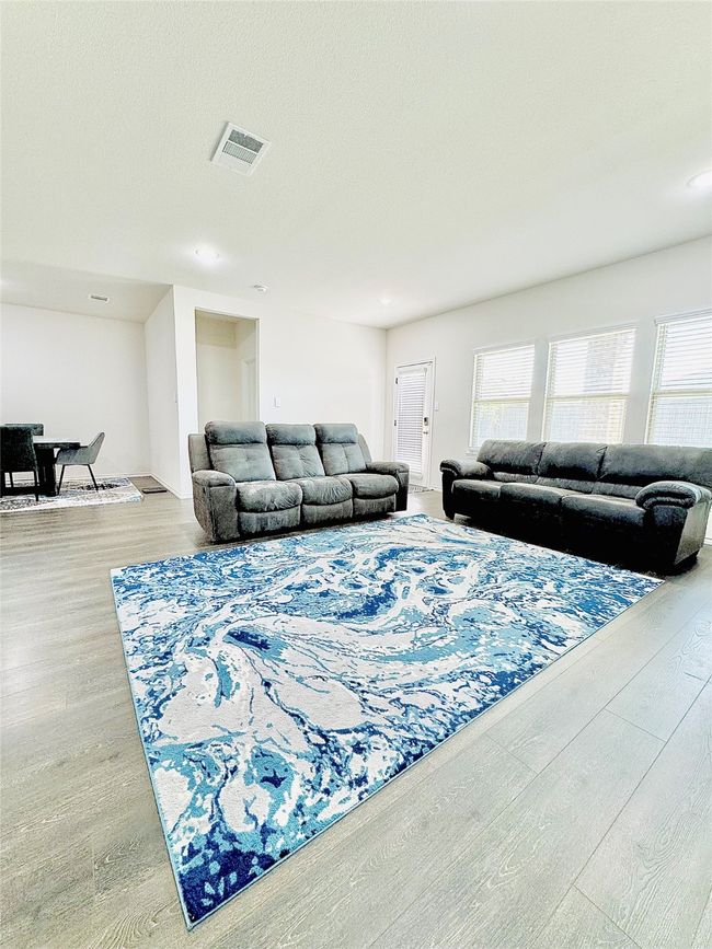 Living room featuring healthy amount of natural light, wood finished floors, and recessed lighting | Image 10