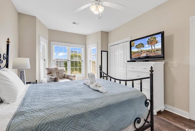 Bedroom featuring ceiling fan, a closet, visible vents, wood finished floors, and baseboards | Image 21