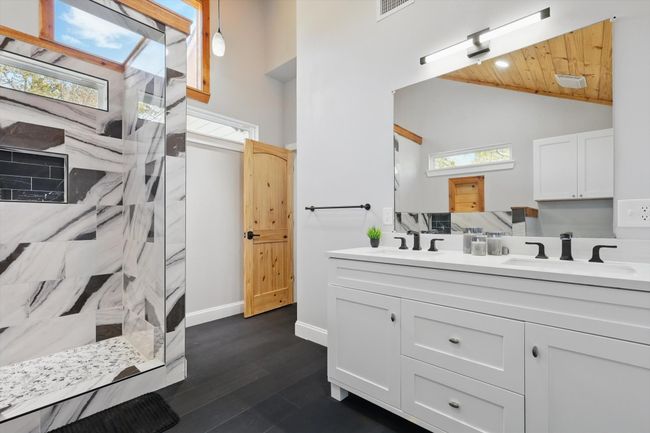 Bathroom featuring a healthy amount of sunlight, a sink, and walk in shower | Image 25