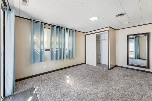 Unfurnished bedroom featuring visible vents, carpet flooring, a closet, and baseboards | Image 23