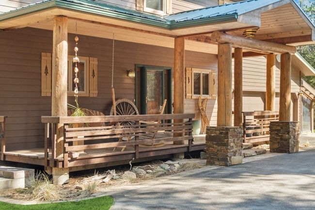 View of exterior entry featuring covered porch and metal roof | Image 36
