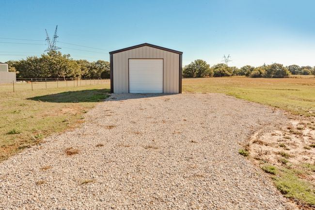 Garage featuring fence and gravel driveway | Image 30