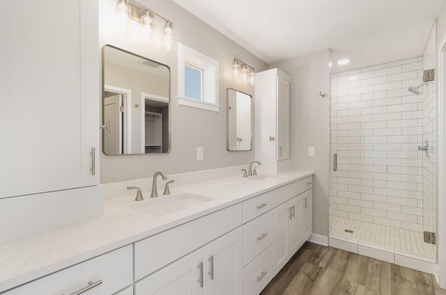 Primary full bathroom features duel vanity, undermount sinks, and duel storage towers. | Image 12