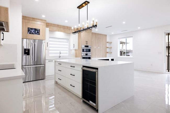Kitchen with stainless steel appliances, modern cabinets, beverage cooler, and recessed lighting | Image 18