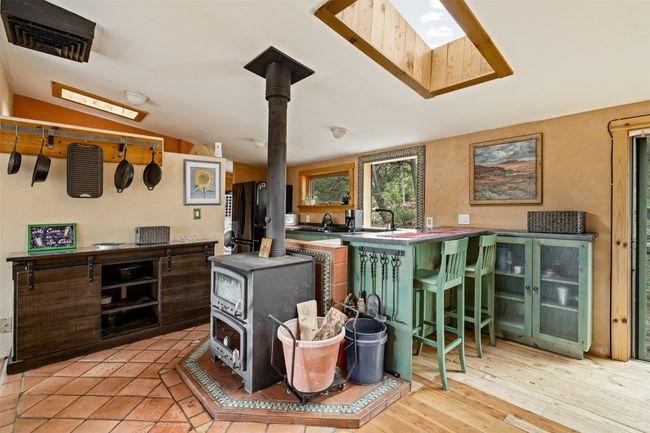 Kitchen, wood burning stove, bar height counters for seating | Image 19