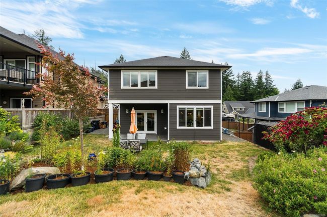 Rear view of house with a fenced backyard and a patio | Image 28