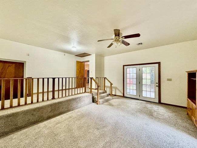 Carpeted empty room with ceiling fan and baseboards | Image 13