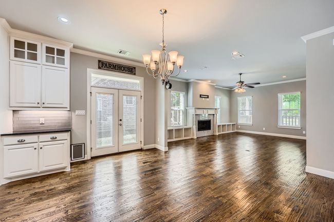 Dining space featuring dark wood finished floors, plenty of natural light, a chandelier, recessed lighting, and ornamental molding | Image 7