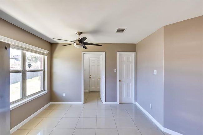 Unfurnished bedroom featuring light tile patterned floors and a ceiling fan | Image 16
