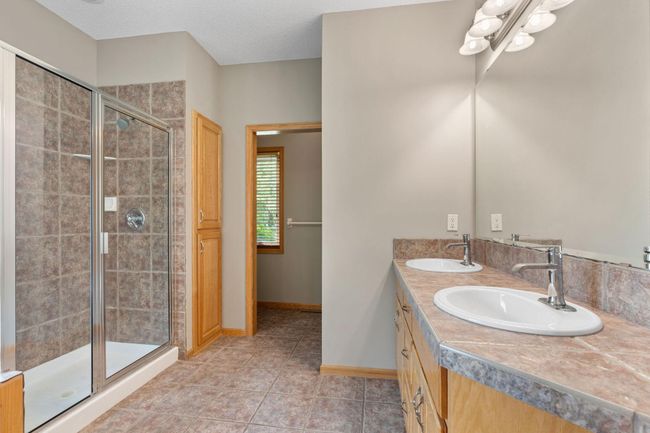 The primary bathroom includes double vanity, walk-in shower, soaking tub, and separate toilet area. | Image 17