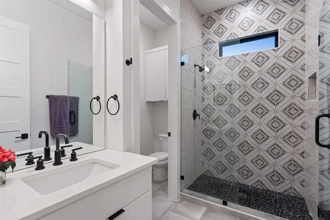 Full bath featuring a shower stall, toilet, and vanity | Image 27