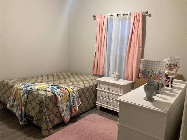 Bedroom with wood finish floors | Image 10