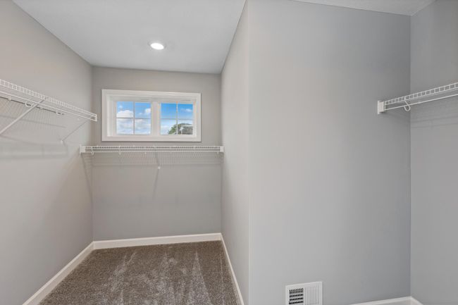 Photo is of the actual model. The primary bedroom features an incredible walk-in closet. | Image 18