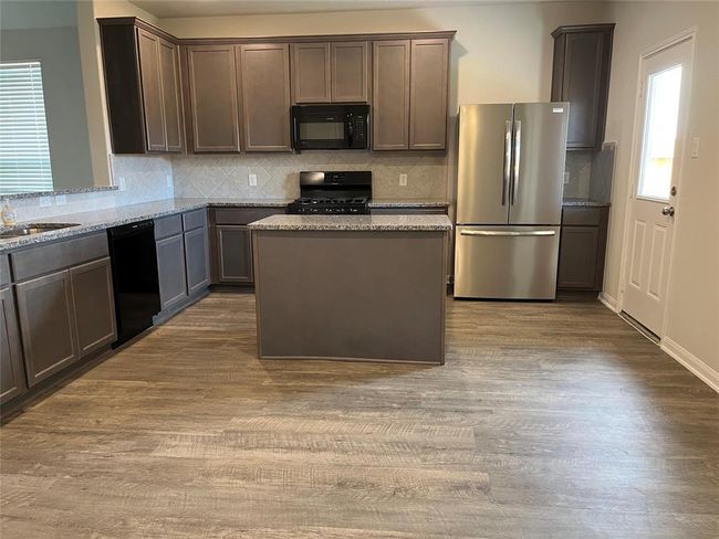 kitchen area with new fridge | Image 19