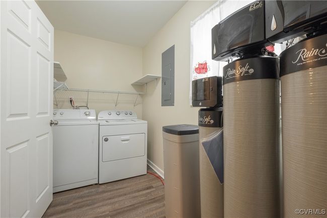 Clothes washing area with wood finished floors, laundry area, electric panel, and washer and dryer | Image 16