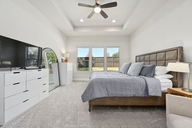 The spacious primary suite provides a tranquil retreat with a walk-in closet and an en-suite bathroom featuring dual vanities, a soaking tub, and a separate shower. | Image 14
