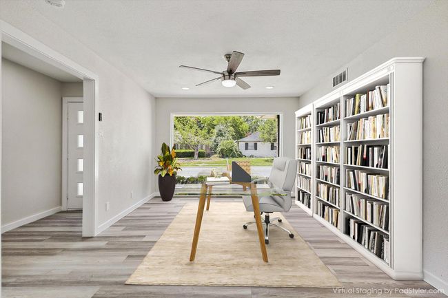 Home office featuring wood finished floors, visible vents, a ceiling fan, and baseboards | Image 7