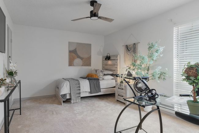 Bedroom with ceiling fan and light carpet | Image 35