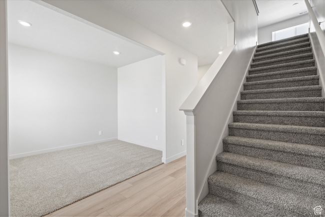 Stairway with wood finished floors and recessed lighting | Image 8