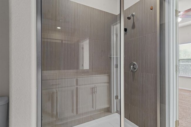 Full bathroom with a tile shower, toilet, and vanity | Image 19