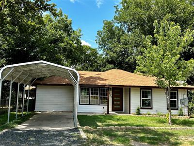 NEW CARPORT ADDED! Ranch-style house featuring a carport and a front yard | Image 1