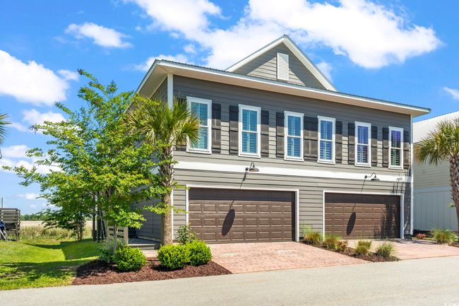 View of front of house with a garage and decorative driveway | Image 4