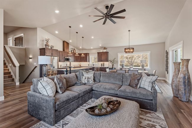 Living area featuring a ceiling fan, dark wood finished floors, healthy amount of natural light, baseboards, and recessed lighting | Image 40