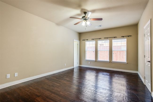 Unfurnished room featuring a ceiling fan, dark wood finished floors, and baseboards | Image 7
