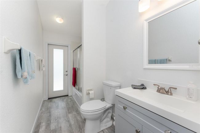 Guest bath has an updated vanity, mirror, and lighting | Image 29