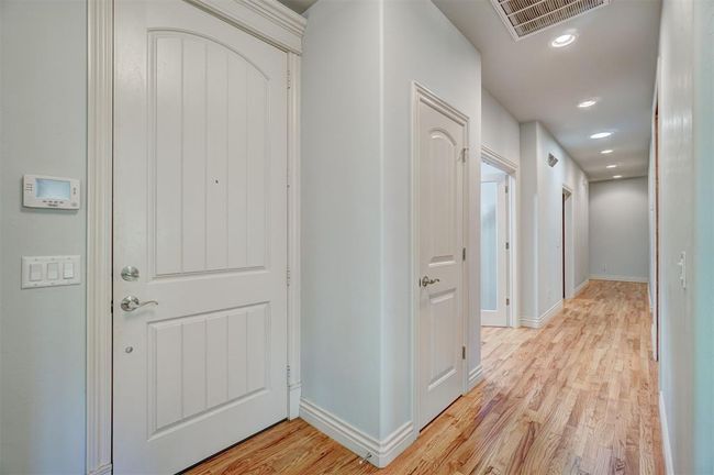 Hallway featuring baseboards, light wood finished floors, visible vents, and recessed lighting | Image 18