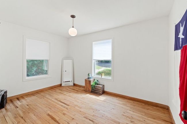 Unfurnished room featuring wood finished floors and baseboards | Image 6
