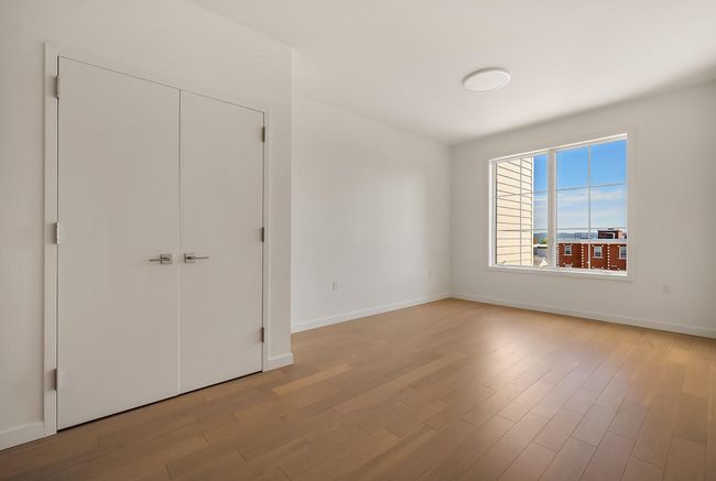 Unfurnished bedroom featuring light wood finished floors, baseboards, and a closet | Image 7
