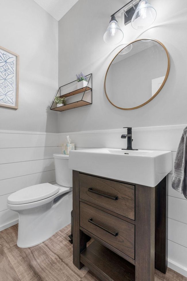 Updated main floor powder bath is located off of the kitchen hallway. | Image 14