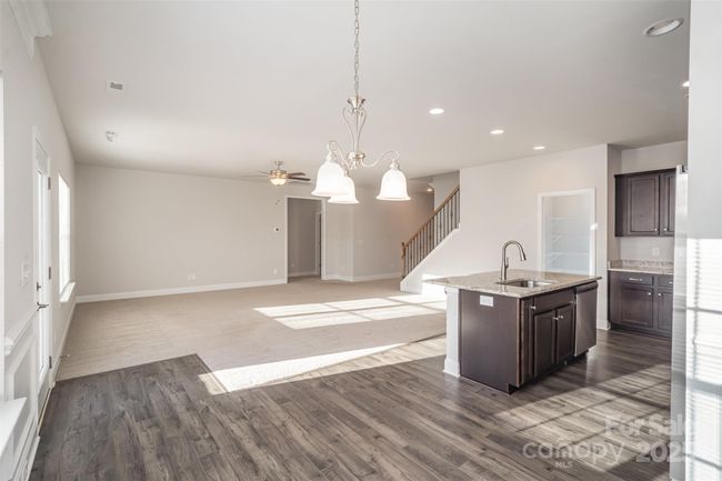 Family Room, Eat-in Dining Area off of the Kitchen, Kitchen island area, walk-in pantry and stairs to the Upper Level. | Image 26