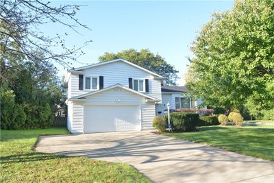 View of front of house featuring a front lawn and a garage | Image 1