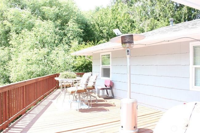 large deck overlooking the creek and outdoor space | Image 18
