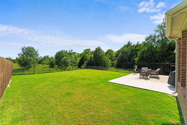 Fenced backyard featuring a patio area | Image 31