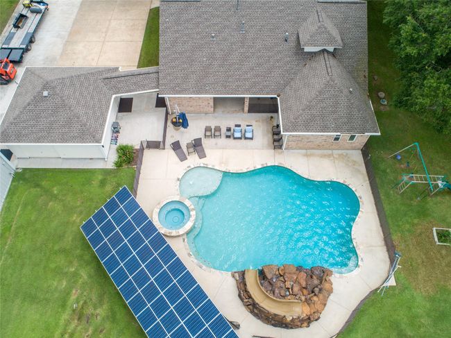 Tucked away on 1.5 serene acres in Manvel, this distinctive property is built for the way you want to live. The flexible floorpan allows between 4 to 6 bedrooms, 2.5 baths, a 2-car garage, in-ground pool, plus a 60'x30' insulated shop. | Image 46