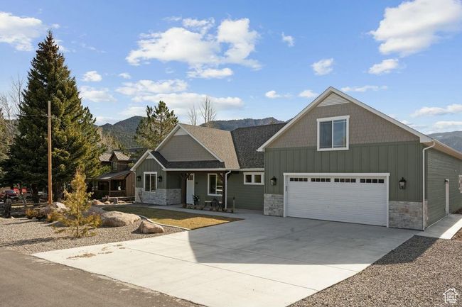 Craftsman-style home featuring board and batten siding, stone siding, and a mountain view | Image 42