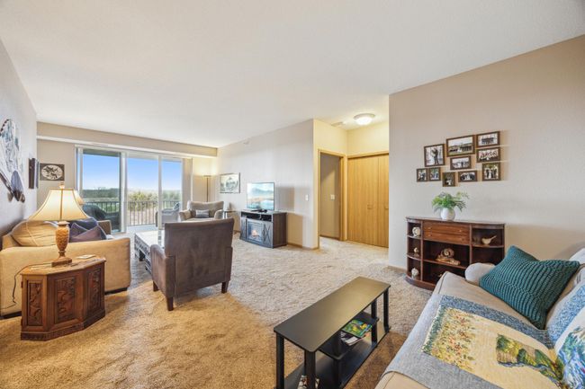 The well-designed floor plan offers additional privacy by splitting the bedrooms and placing the second bedroom, bath and laundry on the opposite side of the living space. Double doors hide the laundry room. | Image 17