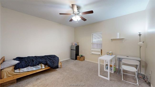 Bedroom with a ceiling fan, baseboards, freestanding refrigerator, and carpet floors | Image 11